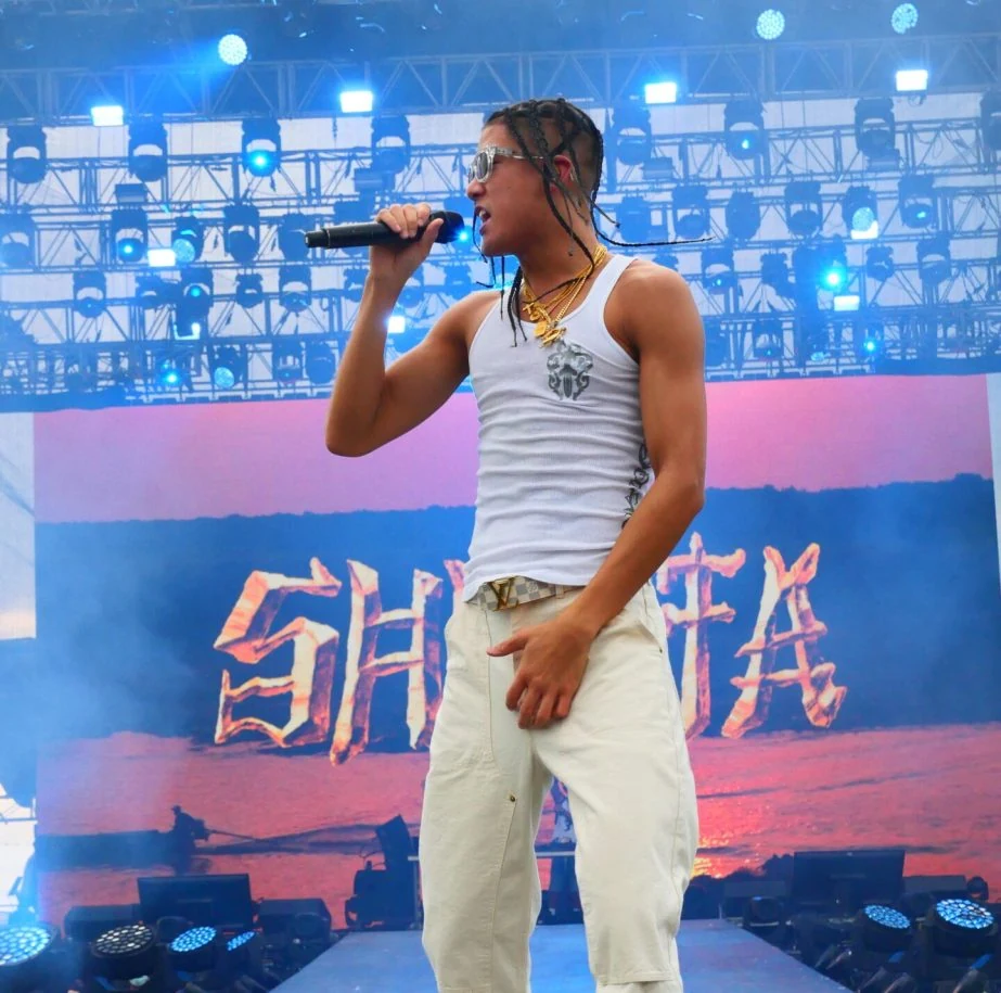 Performer on stage at a live music event.